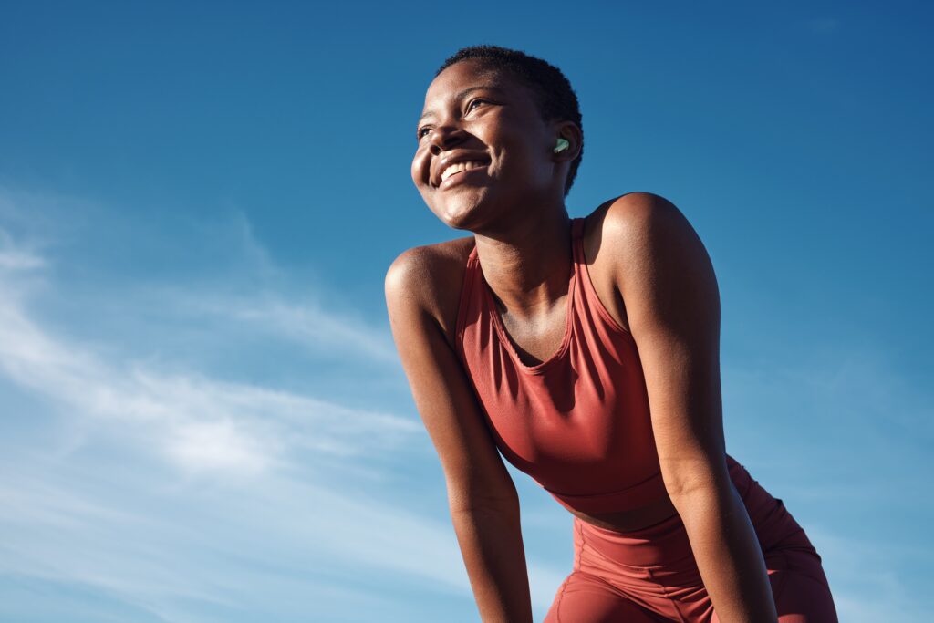 Athletic woman with blue sky in background
